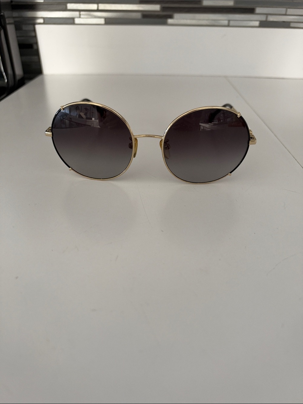 Carolina Herrera Gold Frame Round Sunglasses with Black Gradient Lenses